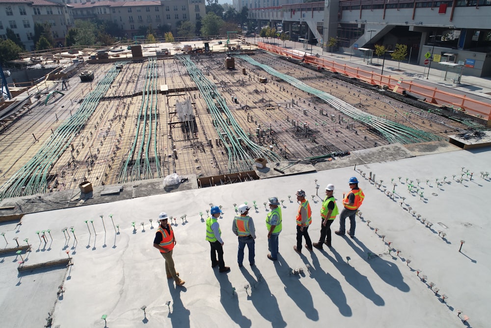 Construction crew reviewing plans on an active job site